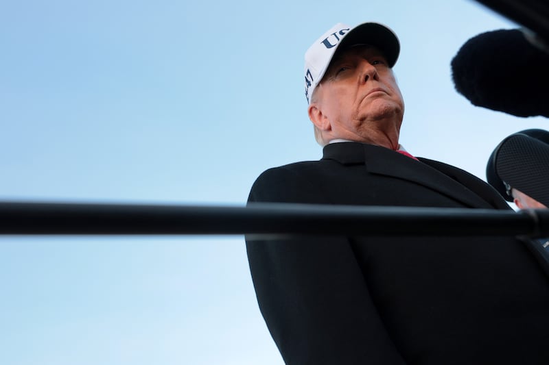 President Donald Trump speaks to the media after arriving at Joint Base Andrews, Maryland on January 13, 2026 .