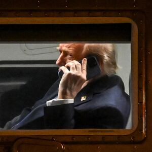 President Donald Trump uses a cellphone aboard Marine One before it departs Leesburg Executive Airport in Leesburg, Virginia, on April 24, 2025.