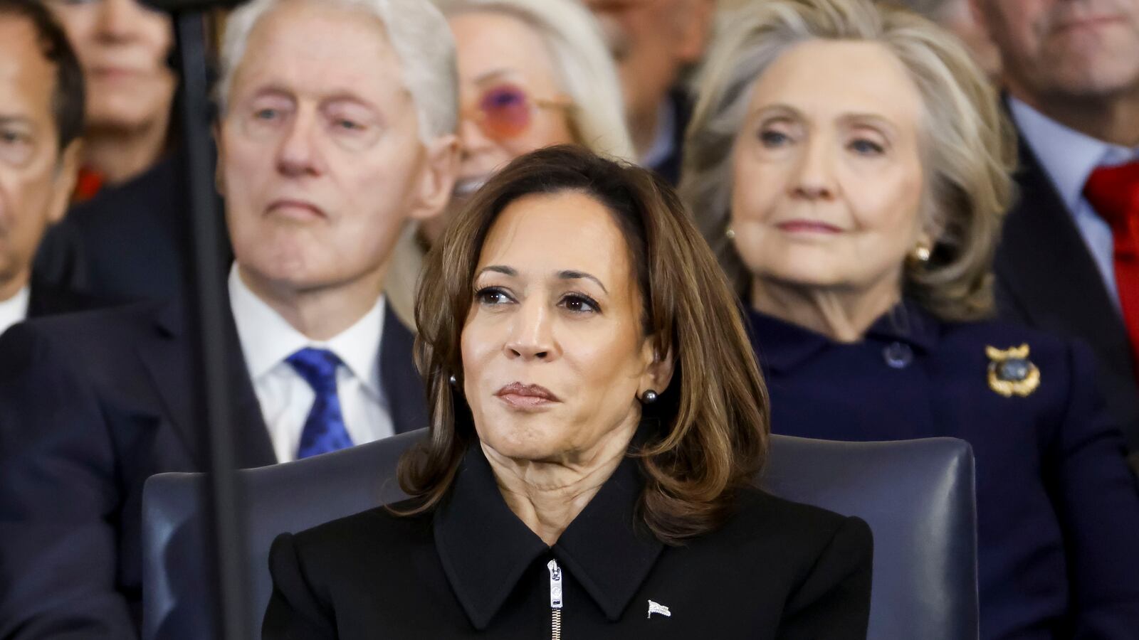 Kamala Harris in front of Bill and Hillary Clinton.