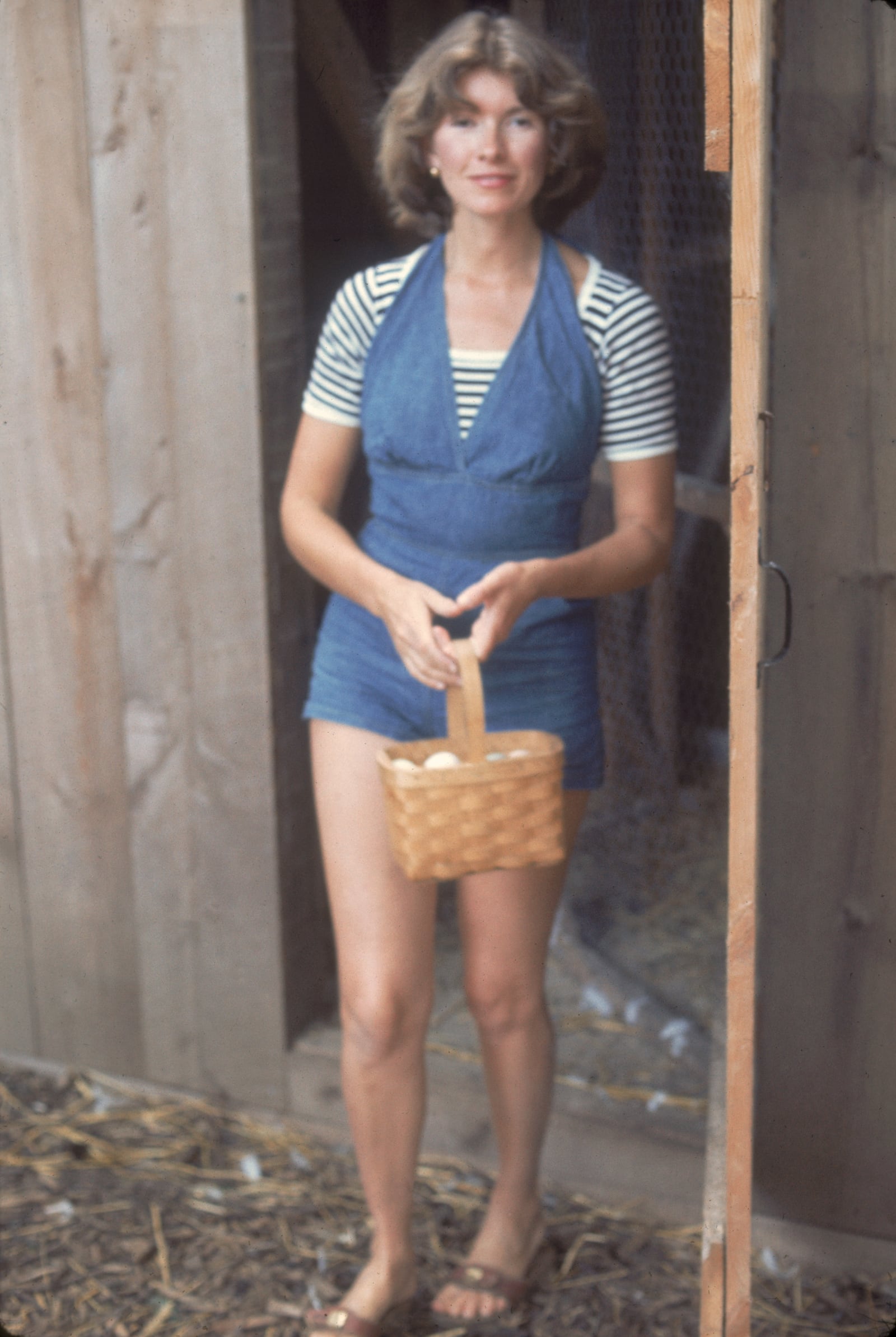 American media mogul and businesswoman Martha Stewart exits a chicken coop with a basket of eggs, August 1976. (Photo by Susan Wood/Getty Images)