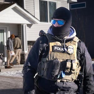CEDAR PINES, MINNESOTA - JANUARY 28: ICE agents look for someone at a home on January 28, 2026 in Circle Pines, Minnesota. Protests continue around the Twin Cities area after the Trump administration sent thousands of immigration agents to the region to search for undocumented immigrants, leading to the deaths of Renee Good on January 7, and Alex Pretti on January 24 in fatal shootings by federal agents.  (Photo by Scott Olson/Getty Images)