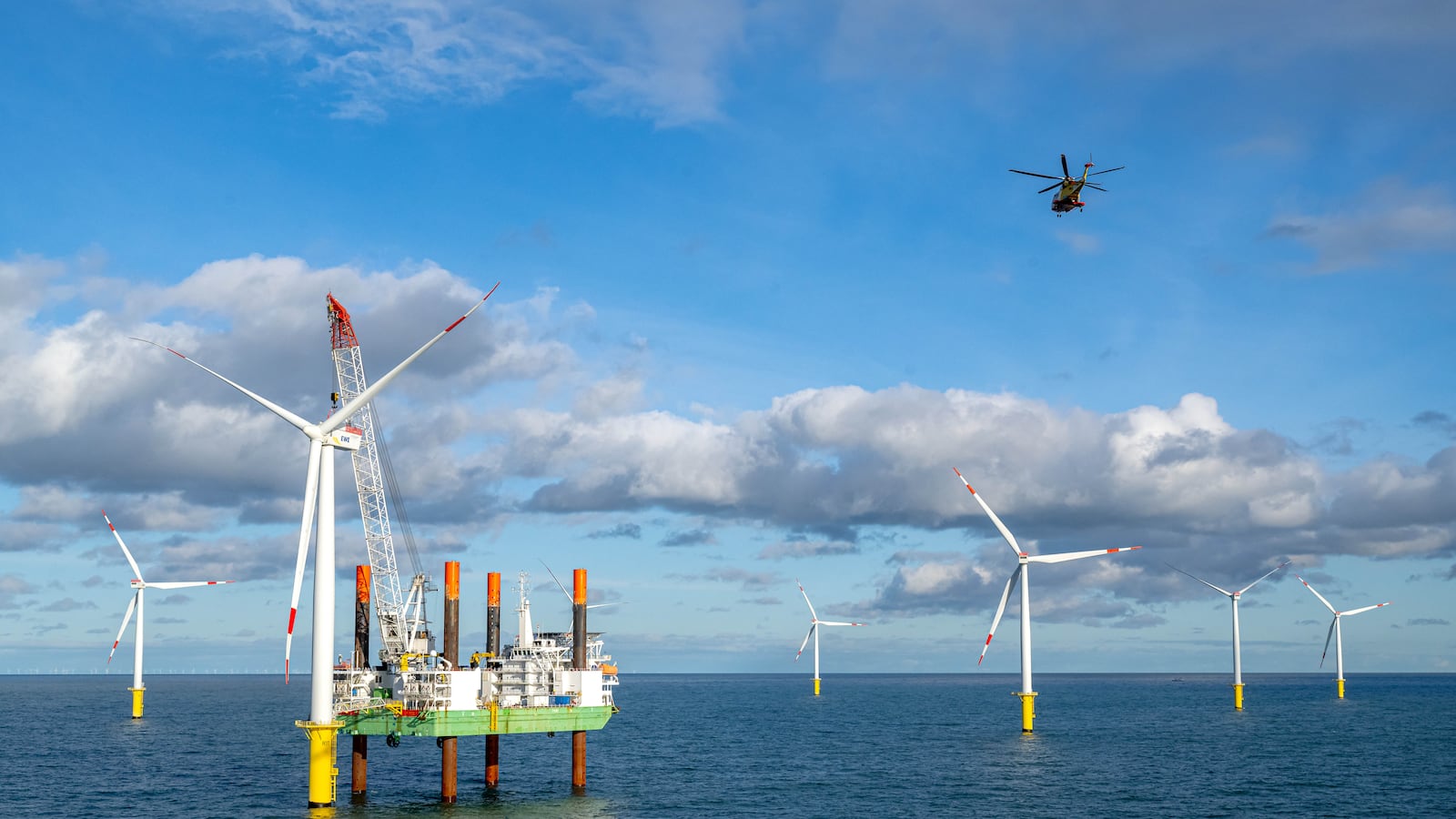 A helicopter flies over the Riffgat offshore wind farm in the North Sea.