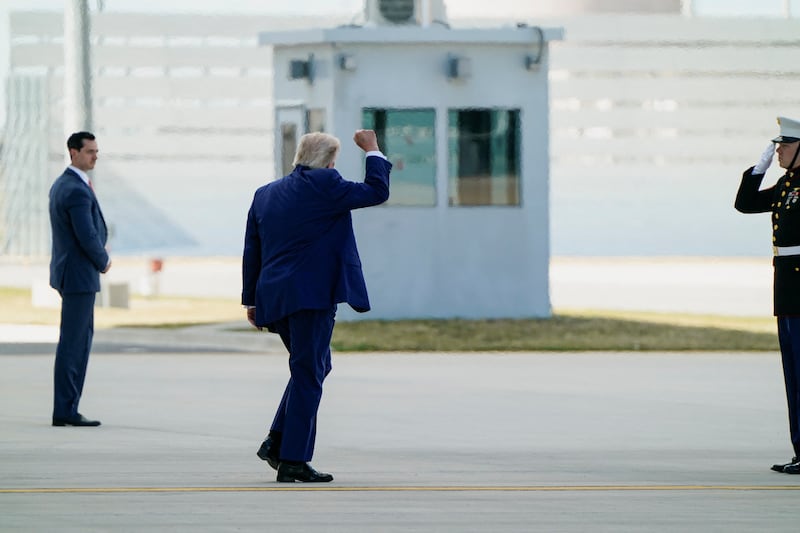 U.S. President Donald Trump makes a fist as he walks to board Marine One en route to Camp David, at Joint Base Andrews, Maryland, U.S., June 19, 2026.