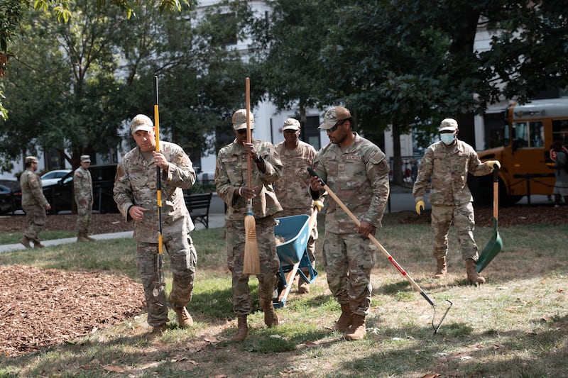 WASHINGTON, DC - AUGUST 28: Air National Guard airmen work clearing leaves and debris from McPherson Square Park on August 28, 2025 in Washington, DC. The Trump administration has deployed federal officers and the National Guard to the District in order to place the DC Metropolitan Police Department under federal control and assist in crime prevention in the nation's capital. (Photo by Andrew Leyden/Getty Images)
