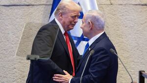President Donald Trump shakes hands and speaks with Israeli Prime Minister Benjamin Netanyahu at the Knesset, Israel's parliament, on the day of Trump's address on October 13, 2025 in Jerusalem.