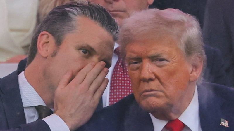 U.S. Secretary of Defense Pete Hegseth talks to U.S. President Donald Trump during the U.S. Army's 250th Birthday parade, on the same day of U.S. President Donald Trump 79th birthday, in Washington, D.C., U.S., June 14, 2025. REUTERS/Carlos Barria     TPX IMAGES OF THE DAY