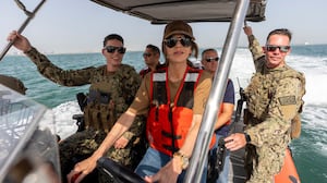 TOPSHOT - US Homeland Security Secretary Kristi Noem (C) pilots an Over the Horizon Small Boat, Mark 4, at Naval Support Activity in Manama on May 25, 2025. (Photo by Alex Brandon / POOL / AFP) (Photo by ALEX BRANDON/POOL/AFP via Getty Images)