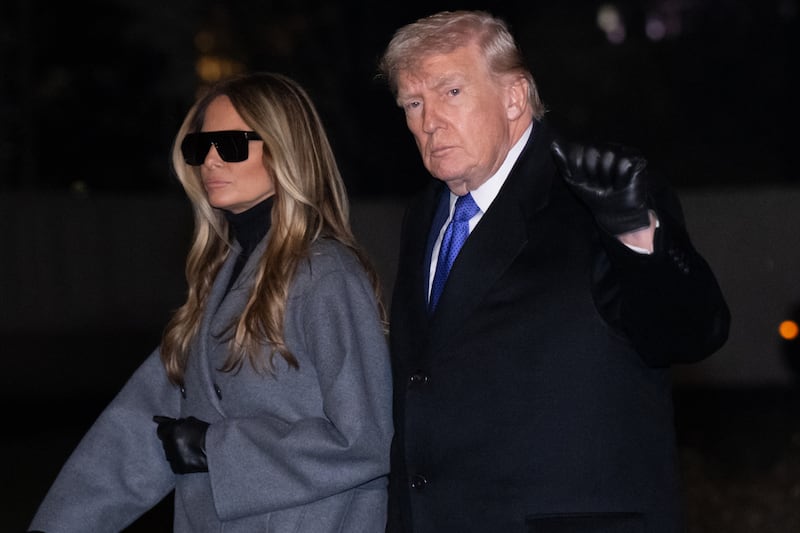 US President Donald Trump and First Lady Melania Trump walk across the South Lawn of the White House after arriving on Marine One following a weekend trip to Florida, in Washington, DC, on February 16, 2026. (Photo by SAUL LOEB / AFP via Getty Images)