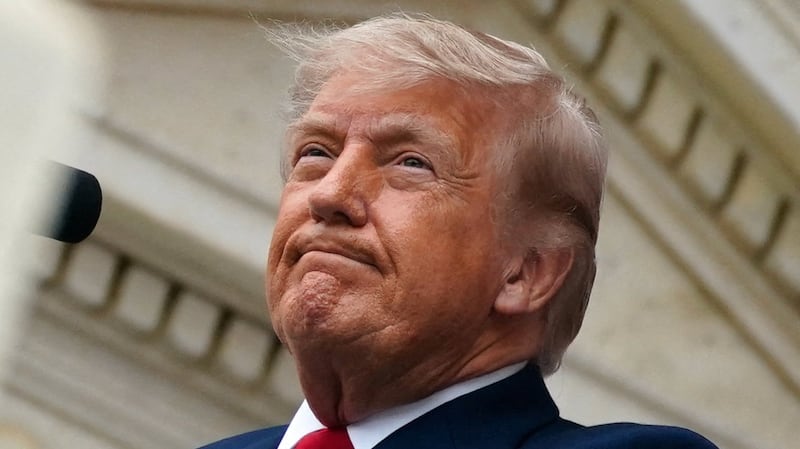 U.S. President Donald Trump looks on as he delivers remarks in the Memorial Amphitheater during a Memorial Day event at Arlington National Cemetery, Arlington, Virginia, U.S., May 25, 2026. REUTERS/Nathan Howard