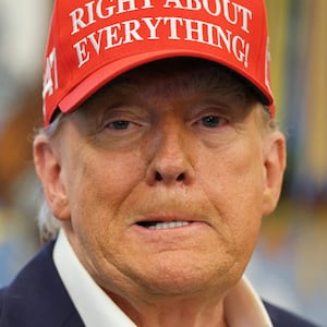 U.S. President Donald Trump wears a 'Trump Was Right About Everything!' hat, as he makes an announcement on the 2026 FIFA World Cup, in the Oval Office at the White House in Washington, D.C., U.S., August 22, 2025. REUTERS/Jonathan Ernst