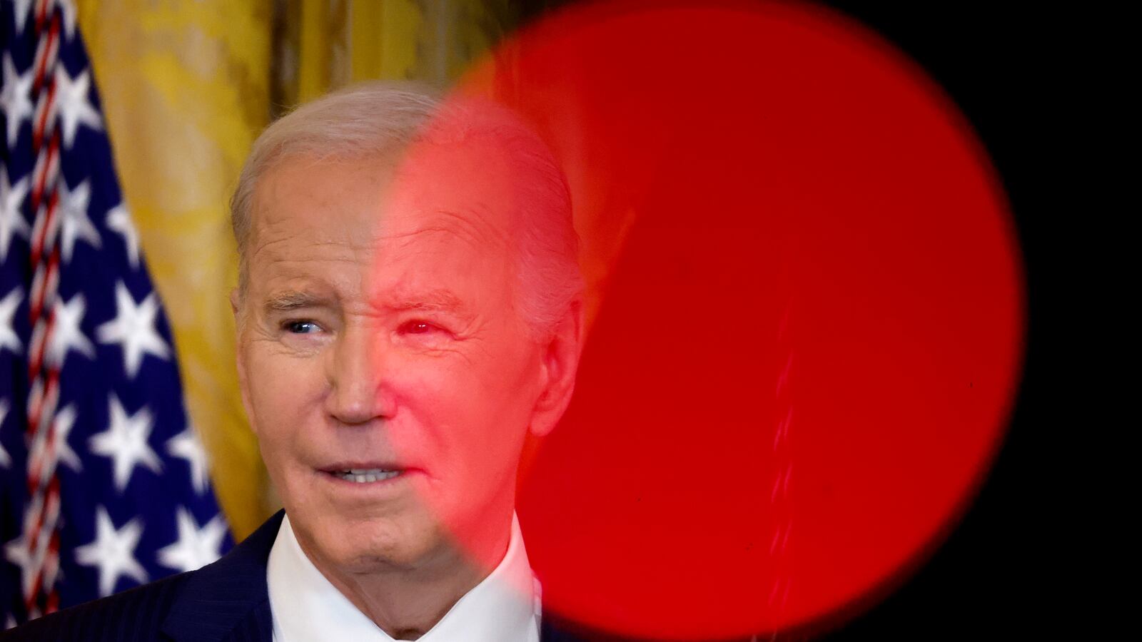 Framed by television camera lights, U.S. President Joe Biden