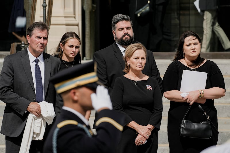 Darline Graham (second right) and her daughter Emillie (right), Darline's husband Larry Nordone (left) and her younger daughter Nicole, along with Emillie's husband Kyle Roberts (rear) were present at National Cathedral for the first of her brother's funeral ceremonies.