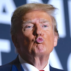 Donald Trump blows a kiss to a member of the audience during a Get Out The Vote rally at the North Charleston Convention Center on February 14, 2024 in North Charleston, South Carolina.