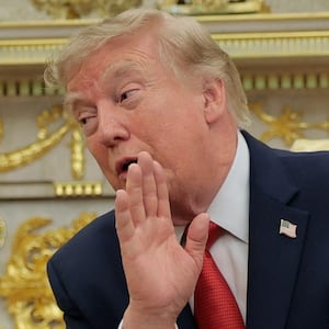 U.S. President Donald Trump speaks as he hosts 16-year-old lifeguard Ryder Williams, who saved a child off the coast of Santa Cruz, California, last month, Nathaniel Rai, the child saved by Williams, and Nathaniel's family members in the Oval Office at the White House in Washington, D.C., U.S., August 17, 2026.