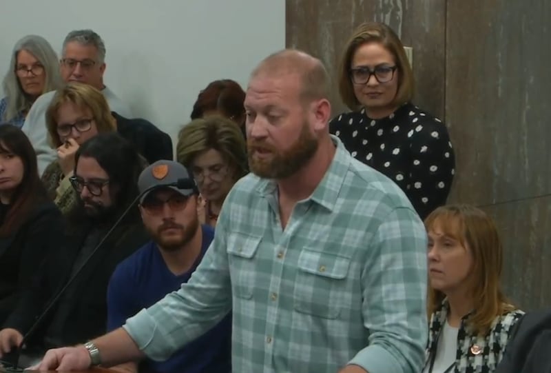 Matthew Ammel (checked shirt) and Kyrsten Sinema (polka dot top) at an Arizona Legislature hearing in 2025.