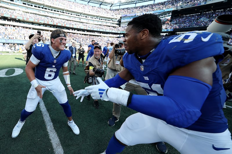 Jaxson Dart #6 of the New York Giants and Abdul Carter #51 of the New York Giants celebrate following a win against the Los Angeles Chargers