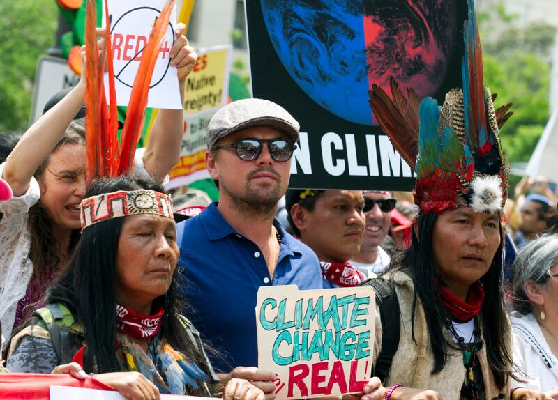 Leonardo DiCaprio (2nd L) marches with a group of indigenous people from North and South America, during the People's Climate March