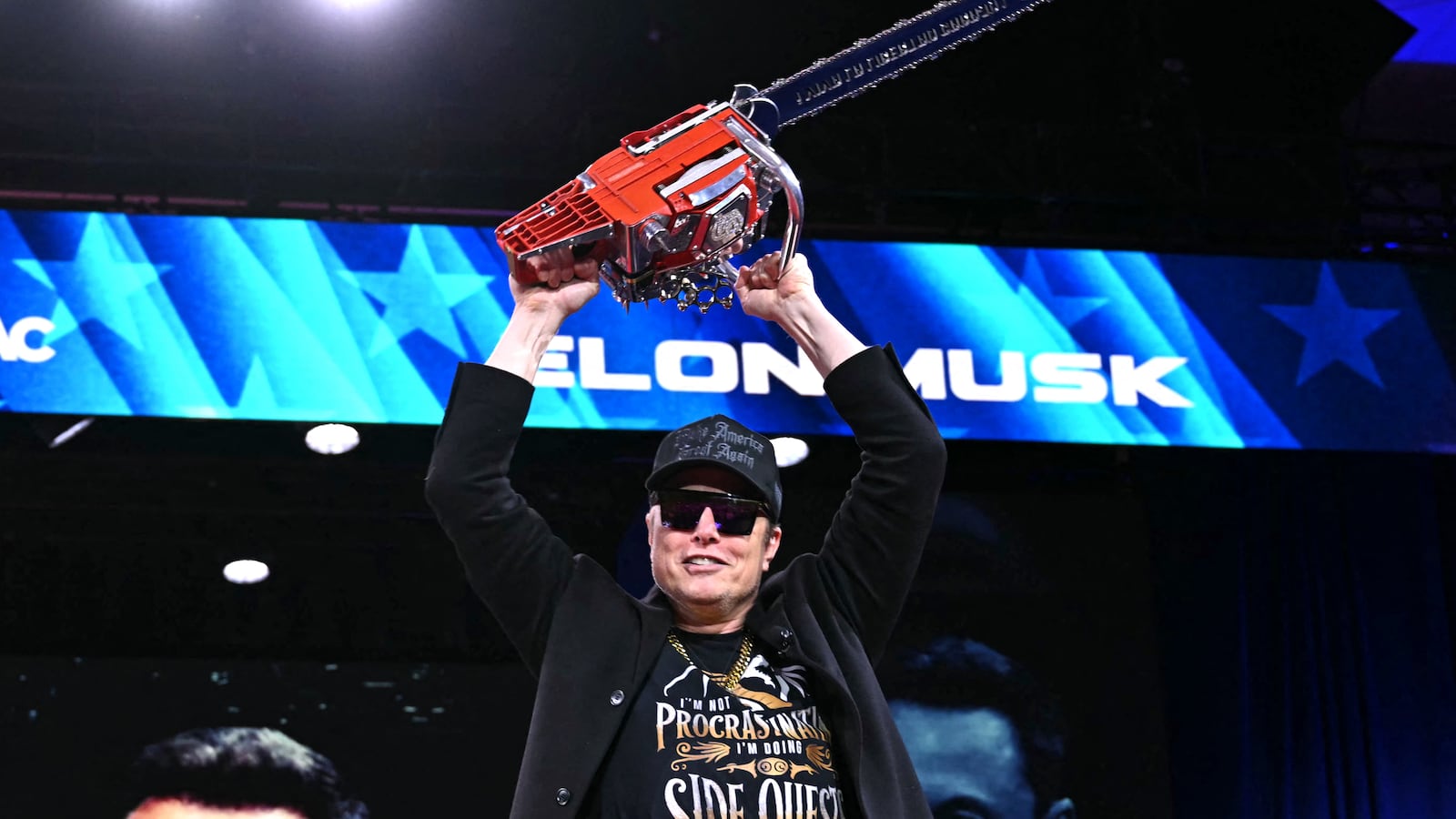 Elon Musk holds a chainsaw reading "Long live freedom, damn it" during the annual Conservative Political Action Conference (CPAC) at the Gaylord National Resort & Convention Center at National Harbor in Oxon Hill, Maryland, on February 20, 2025. The chainsaw was a present to Elon Musk from Argentina's President Javier Milei. (Photo by SAUL LOEB / AFP) (Photo by SAUL LOEB/AFP via Getty Images)