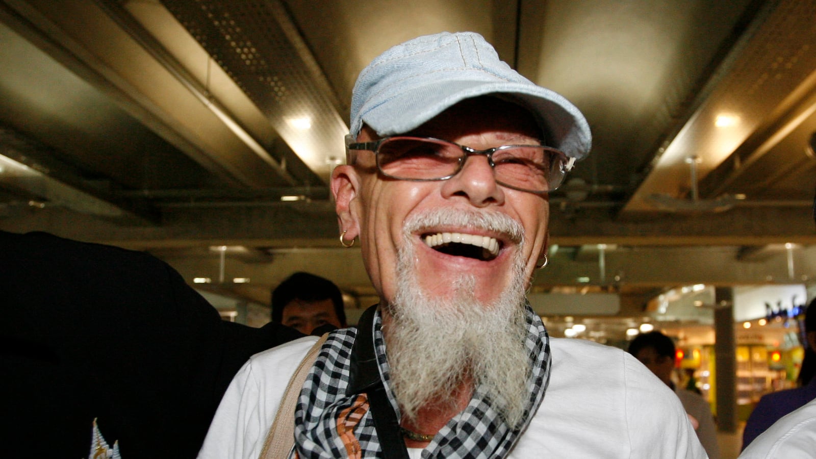 British rocker Gary Glitter walks at Bangkok’s Suvarnabhumi Airport on Aug. 20, 2008.