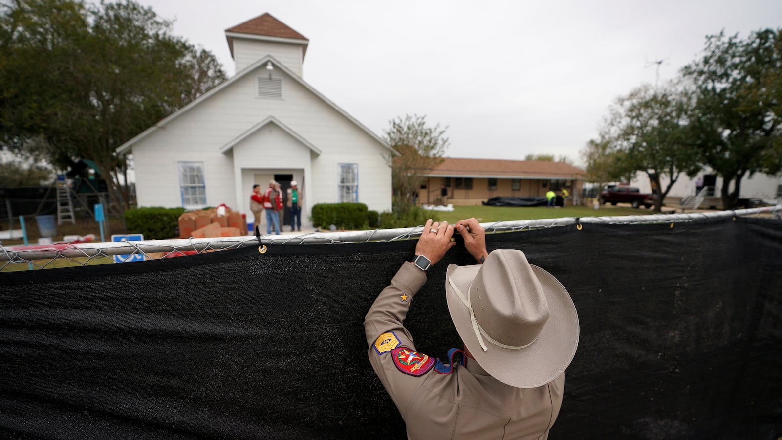 A Texas state trooper helps erect a fence around the site of the shooting at the First Baptist Church of Sutherland Springs, Texas, Nov. 9, 2017.