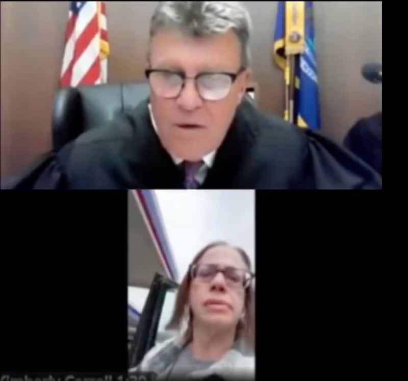 Carroll strides out of the driver's seat.