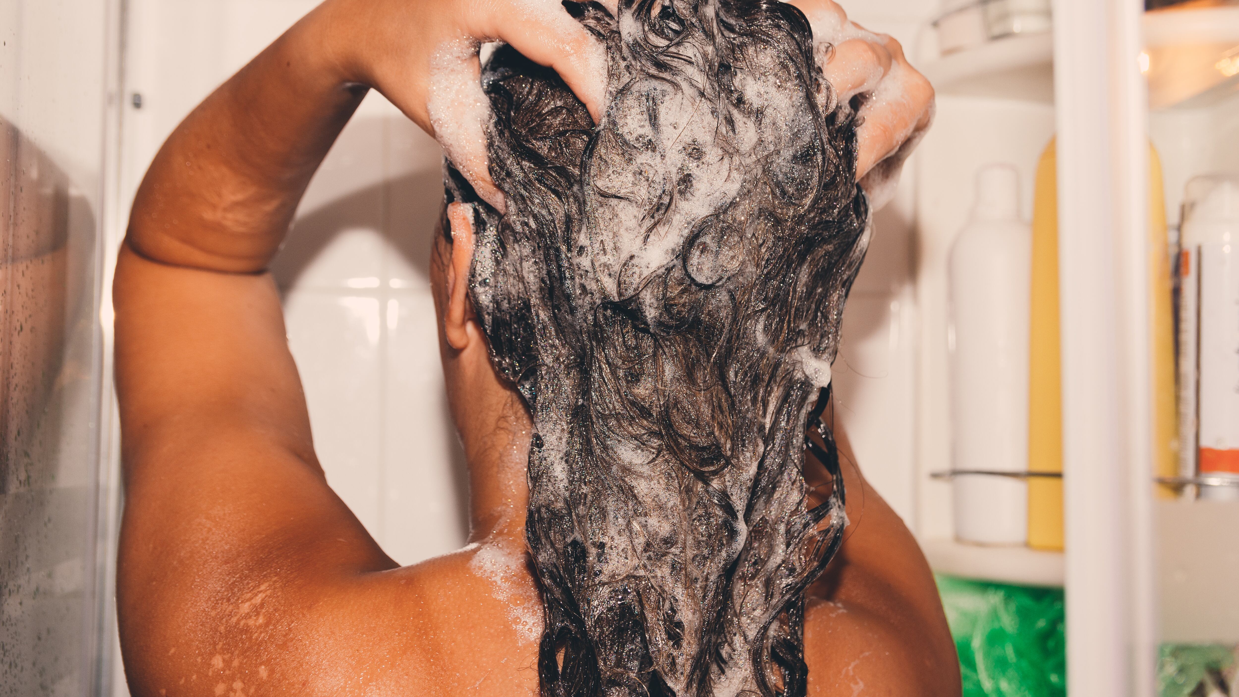 Woman washing her hair in the shower.