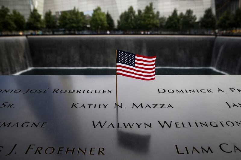 An American flag is seen in the plaque of names on the edge of the South Pool of the 9/11 Memorial  in New York, September 9, 2014.