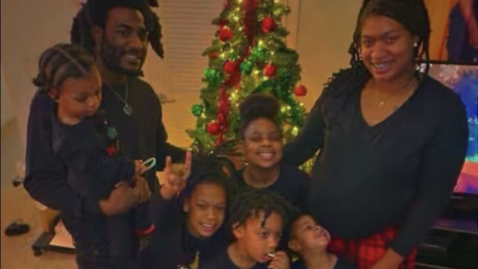 Carolyn Cousin and Cameron Butts Sr. with five of their children as she's pregnant with her sixth.