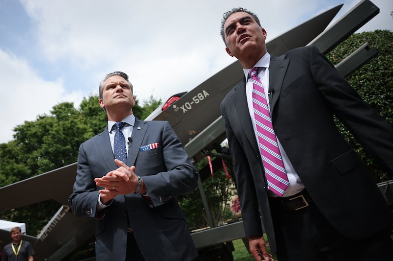 ARLINGTON, VIRGINIA - JULY 16: U.S. Secretary of Defense Pete Hegseth (L) is briefed on the XQ-58A Valkyrie UAS by Emil Michael (R), Under Secretary of Defense (Research & Engineering, while touring an exhibit of Multi-Domain Autonomous systems at the Pentagon July 16, 2025 in Arlington, Virginia. The exhibit, created by the office of the Under Secretary of Defense for Research and Engineering, highlights systems developed for the Defense Department intended to maintain a technological for the U.S. military. (Photo by Win McNamee/Getty Images)