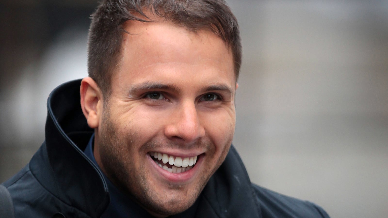 British tabloid journalist Dan Wootton smiles in a photograph.