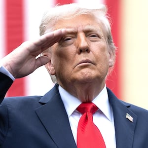 U.S. President Donald Trump salutes during the playing of "Taps" with first lady Melania Trump during a September 11th observance event in the courtyard of the Pentagon September 11, 2025 in Arlington, Virginia.