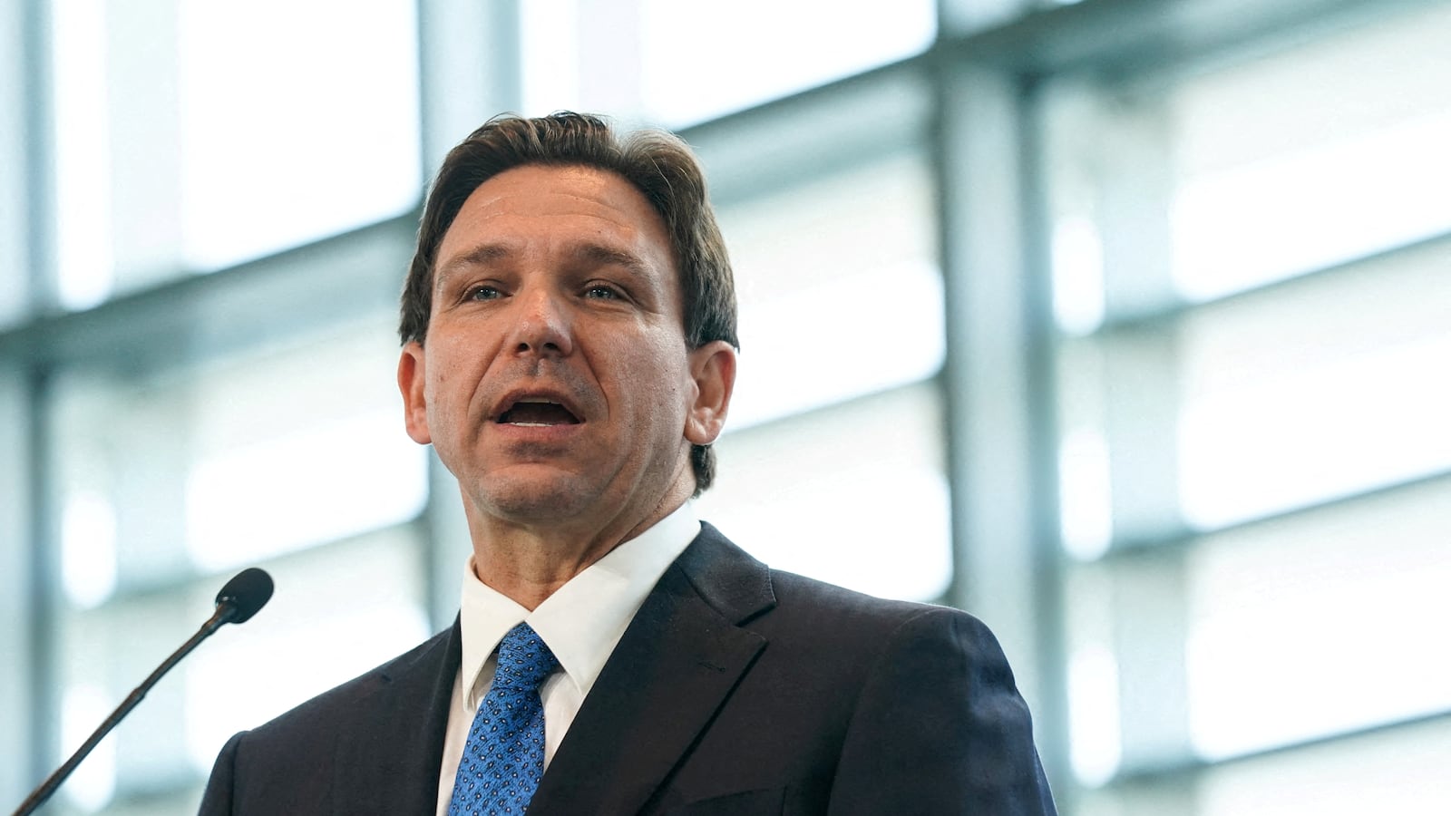 Ron DeSantis stands at a lectern