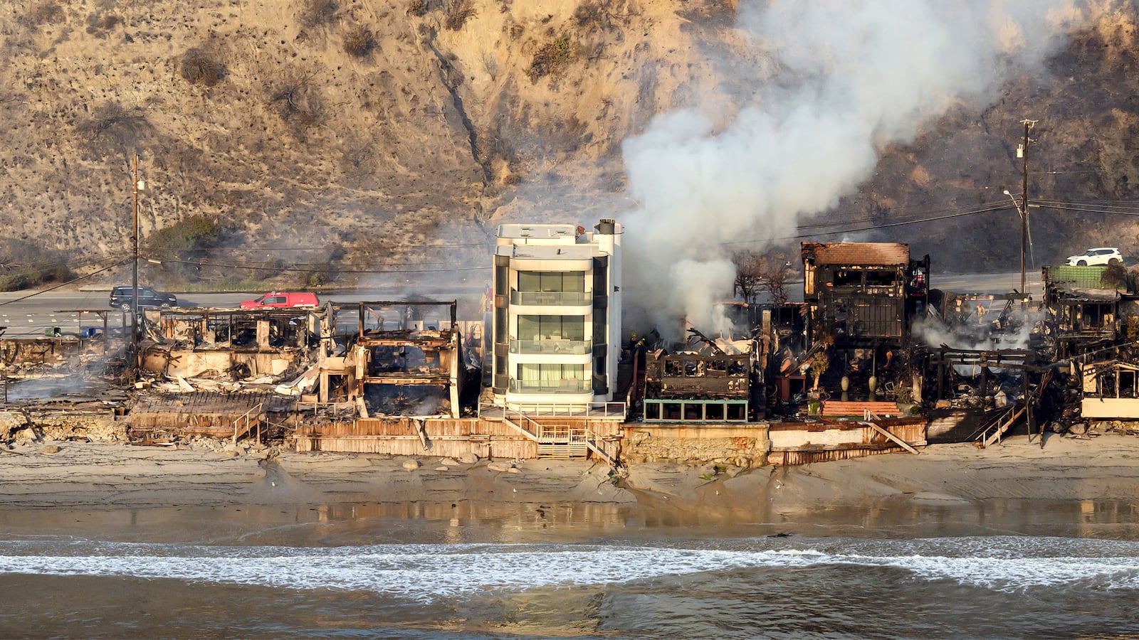 In this aerial view taken from a helicopter, burned homes are seen from above during the Palisades fire in Malibu, Los Angeles county, California on January 9, 2025.