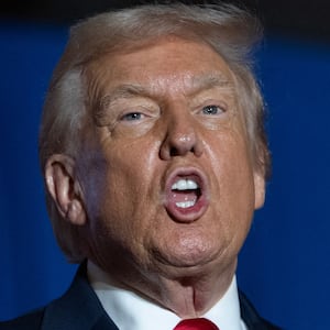 US President Donald Trump sings upon his arrival to deliver remarks on the economy at Mount Airy Casino Resort in Mount Pocono, Pennsylvania, on December 9, 2025. (Photo by ANDREW CABALLERO-REYNOLDS / AFP via Getty Images)