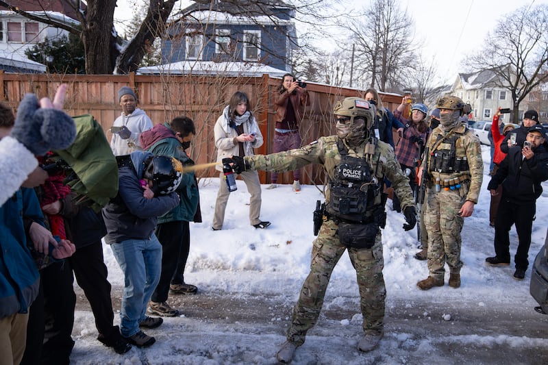 MINNEAPOLIS, MN. - JANUARY 2026: A Border Patrol Tactical Unit agent sprays pepper spray into the face of a protestor attempting to block an immigration officer vehicle from leaving the scene where a woman was shot and killed by a federal agent earlier, in Minneapolis, Minn. on Wednesday, January 7, 2026. The Department of Homeland Security confirmed that a woman was shot and killed by an Immigration and Customs Enforcement (ICE) agent during a confrontation between federal agents and protesters in south Minneapolis. (Photo by Alex Kormann/The Minnesota Star Tribune via Getty Images)