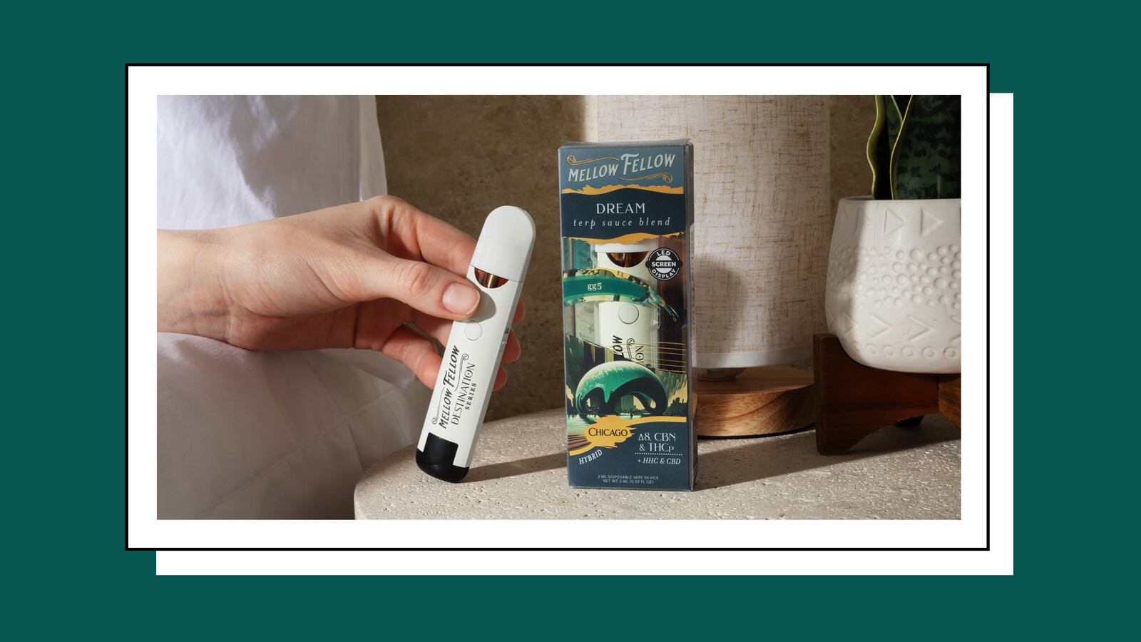 A photo of a person holding Mellow Fellow CBN Vape. To the right is another CBN vape in the packaging.