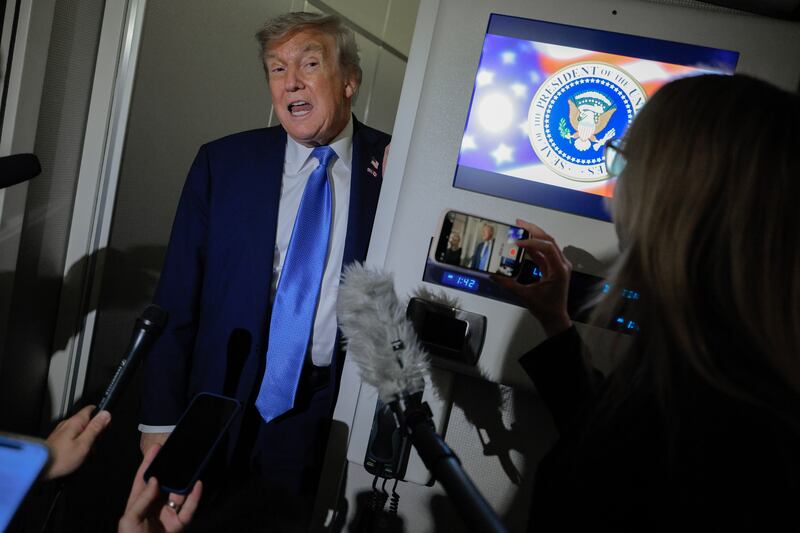 President Donald Trump talks to reporters on board Air Force One after leaving early from the G7 summit on June 16, 2025 in Calgary, Alberta where he was asked about whether he would call Minnesota Governor Tim Walz after the assassination of a state lawmaker and her husband and shooting of a state senator and his wife.