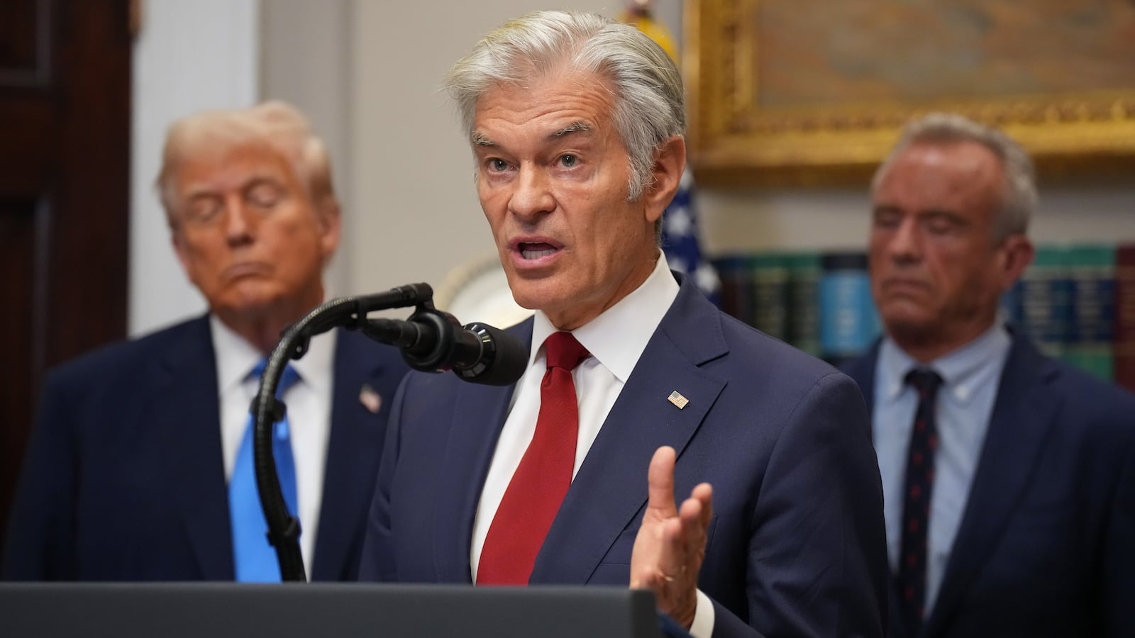 WASHINGTON, DC - SEPTEMBER 22: Administrator for the Centers for Medicare & Medicaid Services Mehmet Oz (C) delivers remarks as U.S. President Donald Trump (L) and U.S. Health and Human Services Secretary Robert F. Kennedy Jr. (R) look on during an announcement by President Donald Trump on “significant medical and scientific findings for America’s children” in the Roosevelt Room of the White House on September 22, 2025 in Washington, DC. Federal health officials suggested a link between the use of acetaminophen during pregnancy as a risk for autism, although many health agencies have noted inconclusive results in the research. (Photo by Andrew Harnik/Getty Images)