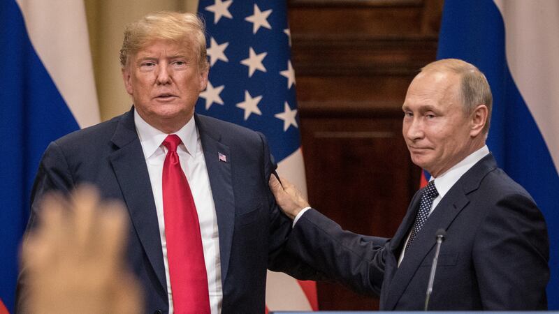 President Donald Trump (L) and Russian President Vladimir Putin shake hands during a joint press conference after their summit on July 16, 2018 in Helsinki, Finland.