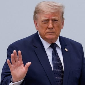 President Donald Trump gestures on the tarmac, as he heads to board the new Qatari-gifted Air Force One en route to New York City, at Joint Base Andrews, Maryland on July 17, 2026.