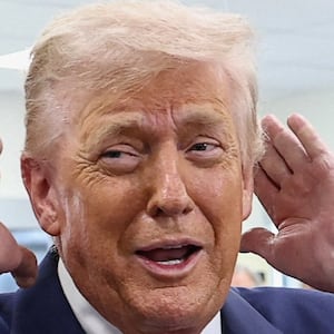 U.S. President Donald Trump checks his hair before sitting down for a podcast interview at the Varsity restaurant, in Rome, Georgia, U.S., February 19, 2026. REUTERS/Kevin Lamarque