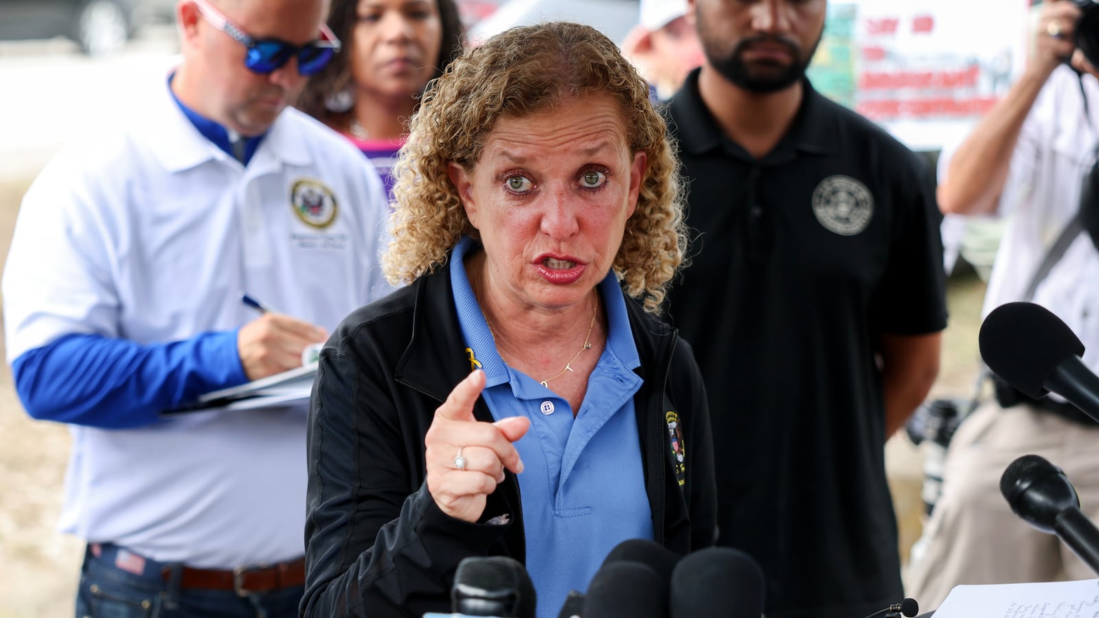 OCHOPEE, FLORIDA - JULY 12: Rep. Debbie Wasserman Schultz (D-FL), Rep. Darren Soto (D-FL) (L), and Rep. Maxwell Frost (D-FL) during a press conference after visiting "Alligator Alcatraz" at the Dade-Collier Training and Transition Airport on July 12, 2025, in Ochopee, Florida. Members of Congress were given their first visit to the new state-managed immigration detention facility in the Florida Everglades that officials have named “Alligator Alcatraz.” (Photo by Joe Raedle/Getty Images)