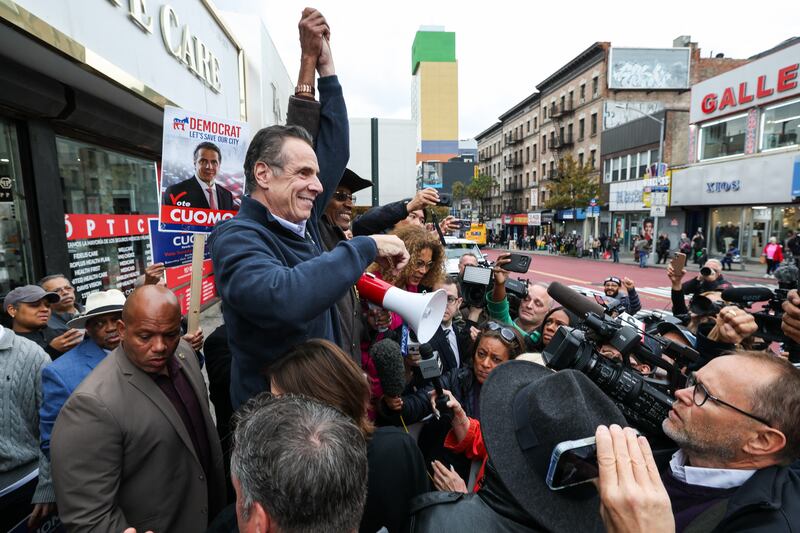 Former New York Governor Andrew Cuomo, independent candidate for New York City mayor, raises his hand with former New York City Council member Ruben Diaz Sr., during a campaign stop in the Washington Heights neighborhood in the Manhattan borough of New York City on November 3, 2025. New Yorkers will pick a new mayor on November 4 after an unpredictable race that has drawn attention from far beyond the largest city in the United States, with President Donald Trump branding frontrunner Zohran Mamdani "a communist." Breakout Democratic Party candidate Mamdani, a naturalized Muslim American who represents Queens in the state legislature, leads former governor and sex assault-accused Andrew Cuomo, running as an independent after losing his party's primary contest to Mamdani. (Photo by TIMOTHY A.CLARY / AFP) (Photo by TIMOTHY A.CLARY/AFP via Getty Images)