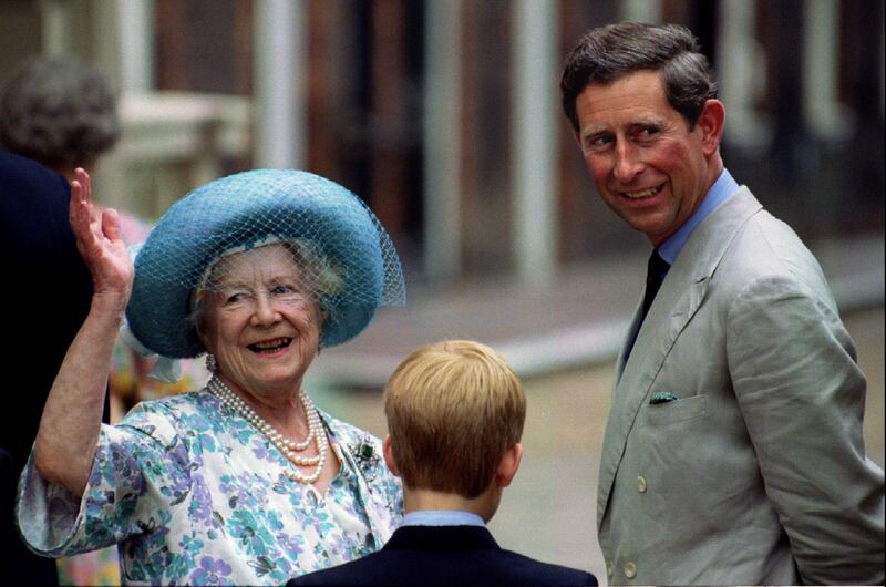 The Queen Mother waves to well-wishers gathered at Clarence House for her 94th birthday as Prince Charles and Prince Harry escort her, August 4th, 1994.