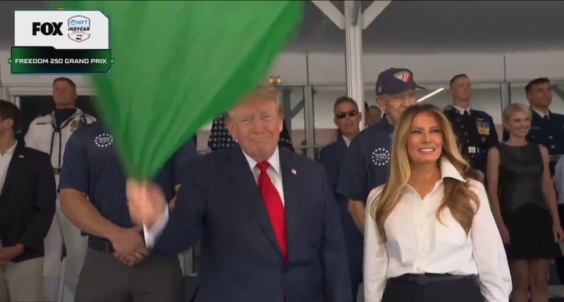The full image, with Natalie Harp visible over Melania's right shoulder.