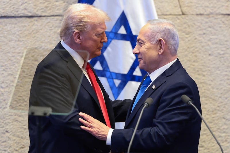 US President Donald Trump (L) speaks with Israeli Prime Minister Benjamin Netanyahu at the Israeli parliament, the Knesset, in Jerusalem on October 13, 2025.