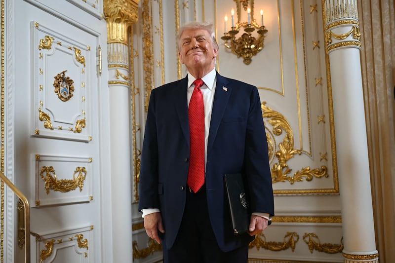 US President Donald Trump reacts as he arrives at a dedication ceremony for Southern Boulevard, in the ballroom at Mar-a-Lago in Palm Beach, Florida, on January 16, 2026. Palm Beach Southern Boulevard, between Kirk Road and South Ocean Boulevard, is being renamed as "President Donald J. Trump Boulevard." (Photo by ANDREW CABALLERO-REYNOLDS / AFP via Getty Images)