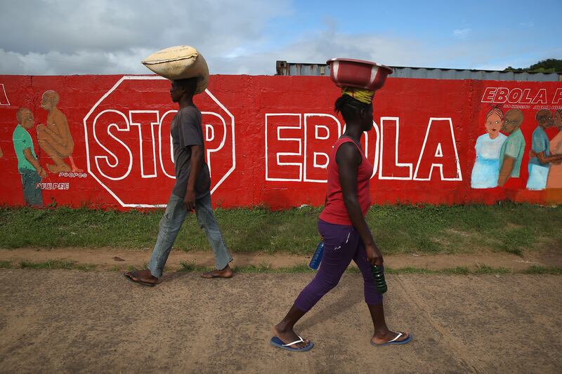 galleries/2014/10/23/portrait-of-an-epidemic-the-front-lines-of-ebola/141022-john-moore-ebola-14_cpdnrr