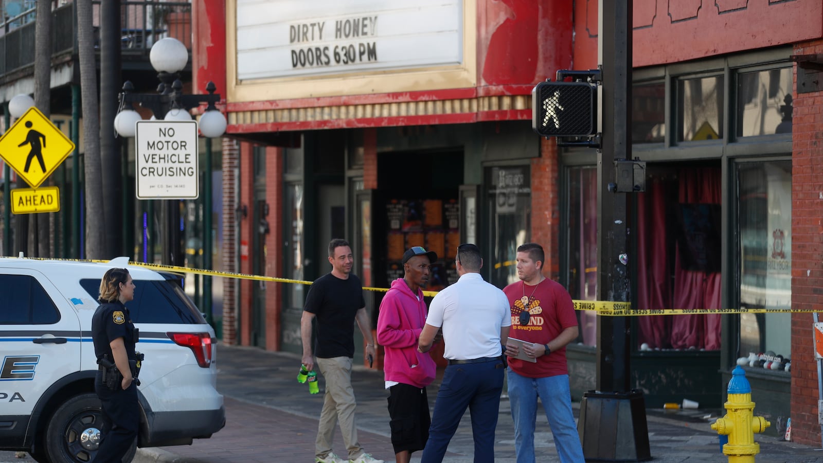 Police stand on the street in the Ybor City neighborhood in Tampa after a deadly mass shooting.
