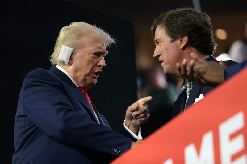 U.S. President Donald Trump speaks with Tucker Carlson